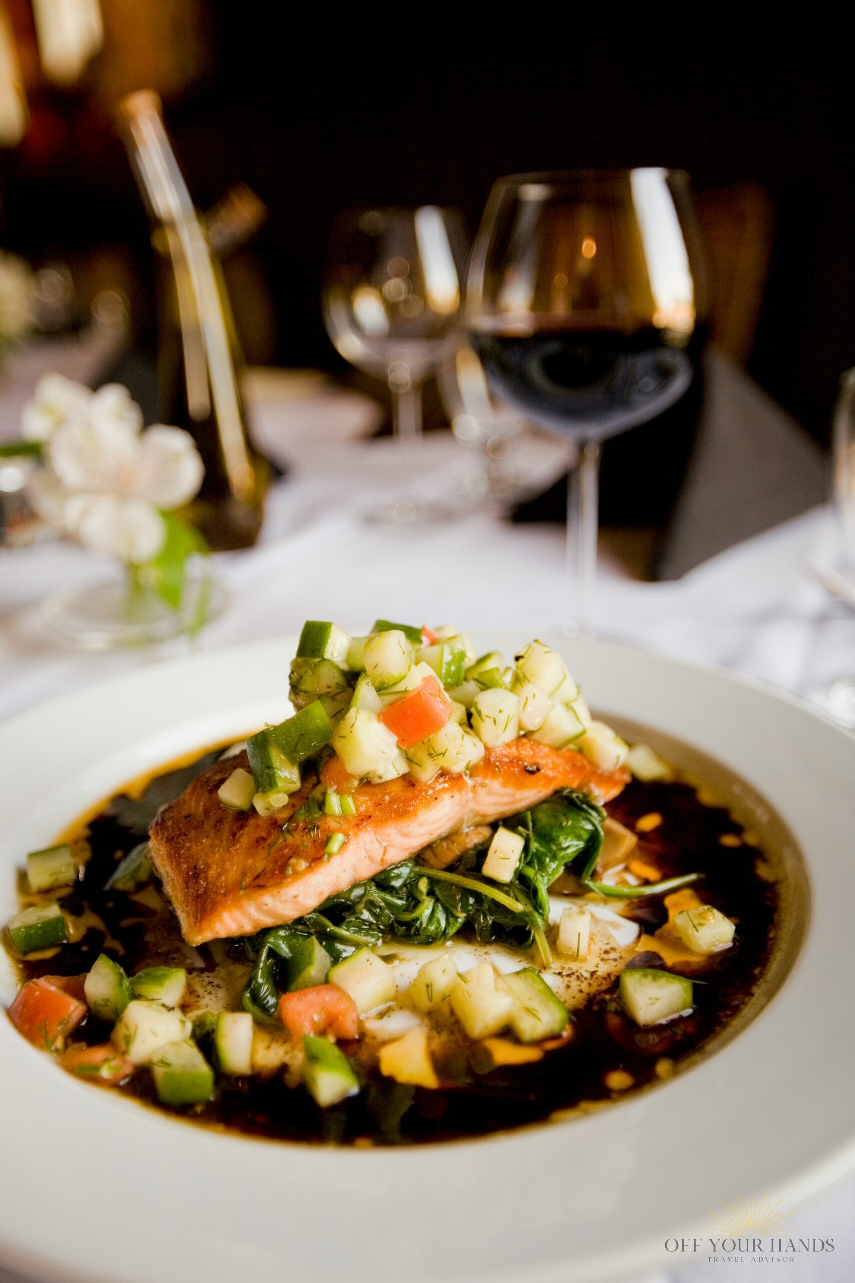 Gourmet salmon dish with cucumber salsa on a white plate, perfect for foodies.