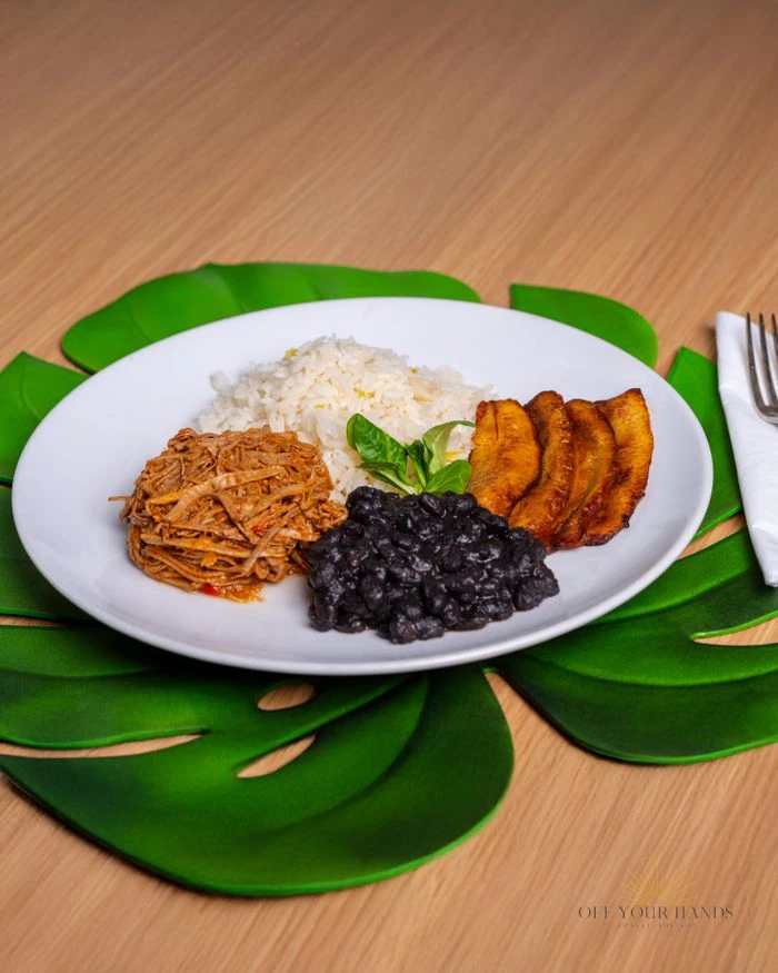 Authentic Latin American dish with pulled beef, black beans, rice, and plantains.